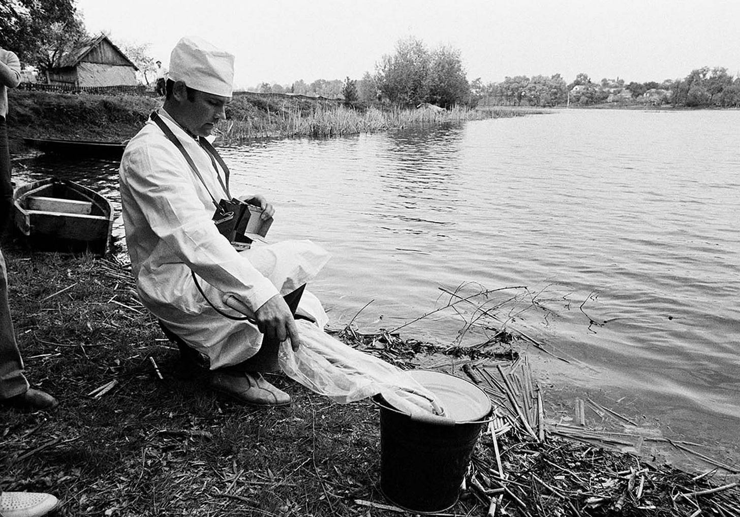 A Soviet technician meticulously checks water for radiation near Kiev on May 9, 1986, amidst hourly tests to ensure water safety post-Chernobyl.