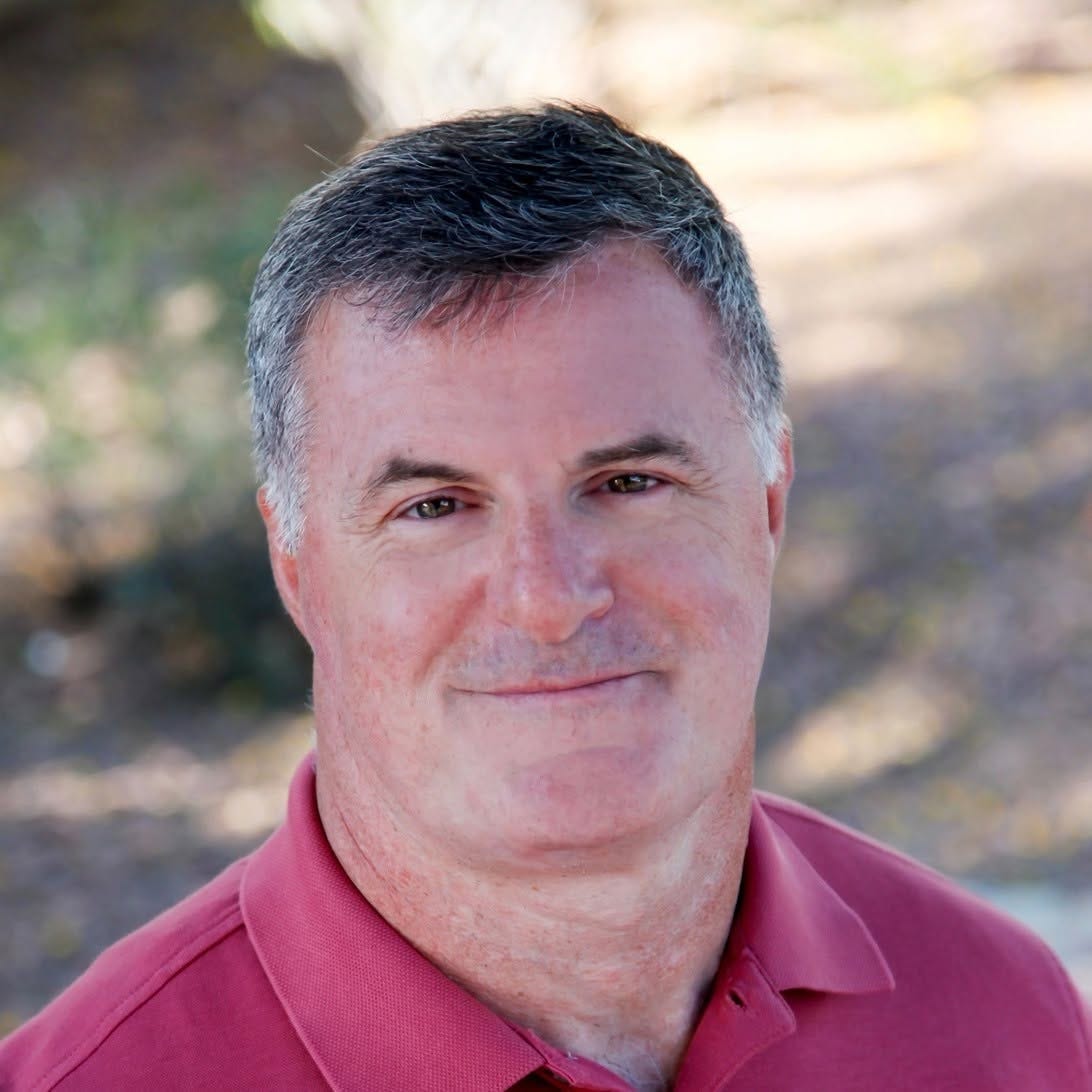 Attorney Dale Saran of Military Back Pay, smiling outdoors in a red polo shirt Attorney Dale Saran of Military Back Pay, smiling outdoors in a red polo shirt