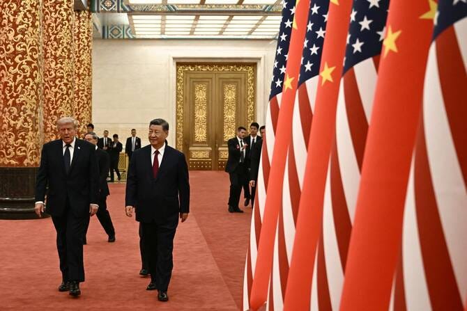 Trump’s visit to China appeared to be more about a declining empire attempting to manage its own contraction (File/AFP)