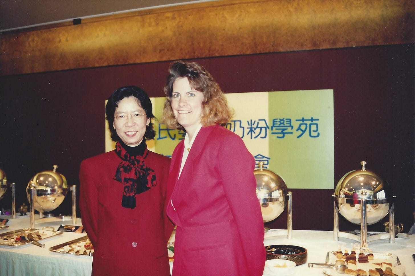 Young American business woman poses with a Taiwanese businesswoman colleague at a dinner meeting in Taiwan Young American business woman poses with a Taiwanese businesswoman colleague at a dinner meeting in Taiwan