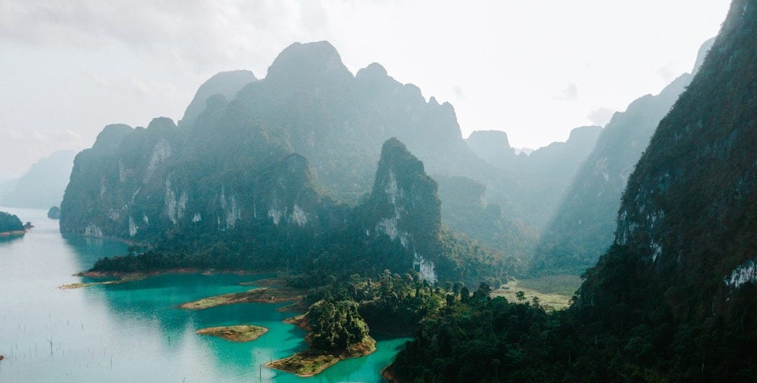 a body of water surrounded by mountains and trees