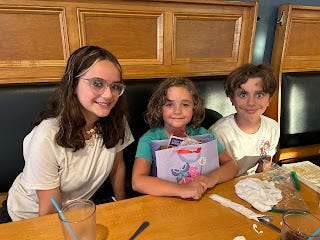My two nieces (15, 9) and nephew (13) sitting in the booth of a restaurant. My two nieces (15, 9) and nephew (13) sitting in the booth of a restaurant.
