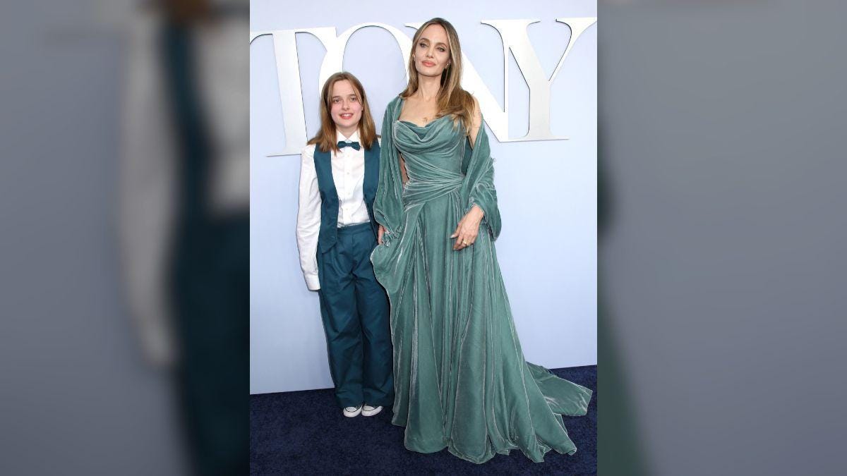 Photo of Angelina Jolie's daughter Vivienne dressed casually in a black T-shirt and brown pants. Photo of Angelina Jolie's daughter Vivienne dressed casually in a black T-shirt and brown pants.