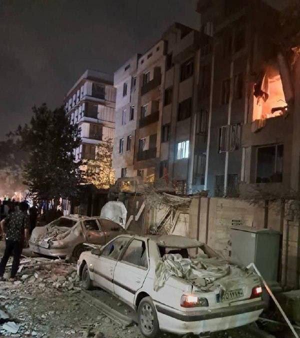 Damage to a building and cars after an Israeli attack in Tehran, Iran.