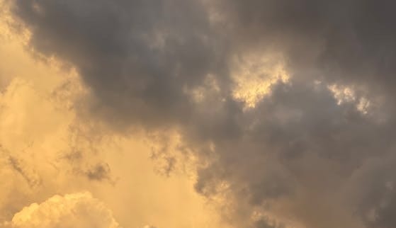 Free A captivating view of dramatic clouds with a warm, sepia tone, perfect for backgrounds and wallpapers. Stock Photo