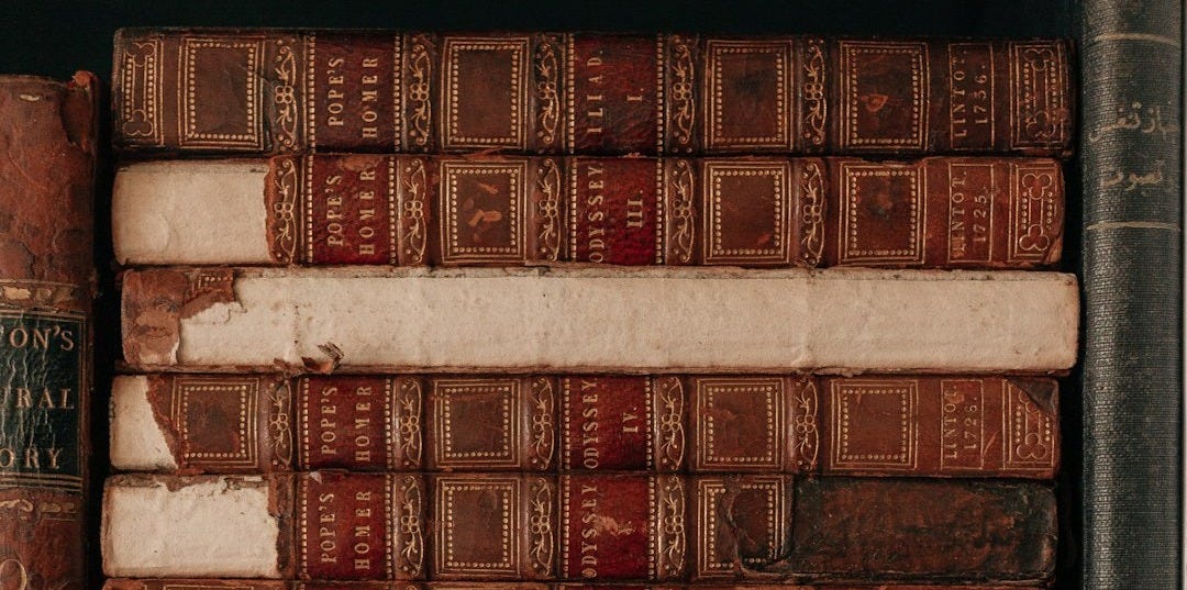 brown and white books on shelf