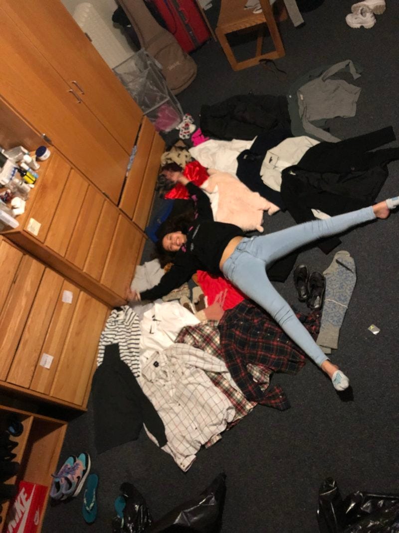 me lying down in a sea of free clothes