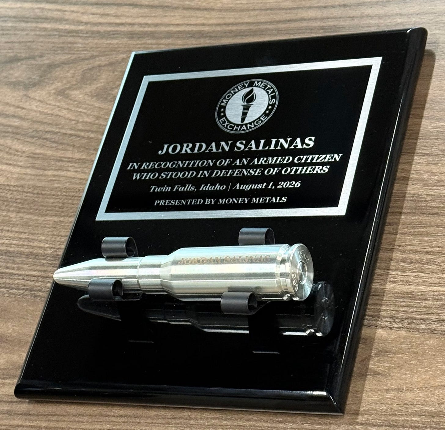 Twin Falls Hero Jordan Salinas Honored by Money Metals With Silver Bullet 2 Plaque that says JORDAN SALINAS, IN RECOGNITION OF AN ARMED CITIZEN WHO STOOD IN DEFENSE OF OTHERS, Twin Falls, Idaho | August 1, 2026, PRESENTED BY MONEY METALS