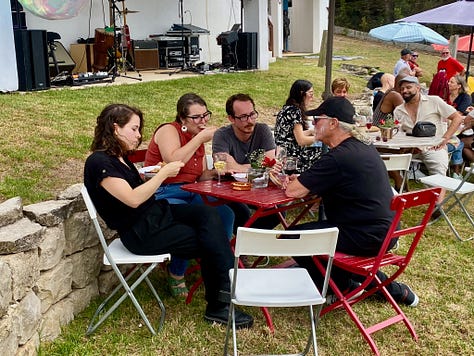people outside having a party, playing live music and a swimming pool and bbq