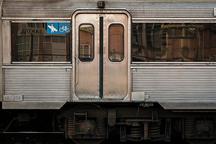 Horizontal lines on a train and an old warehouse, in Lisbon