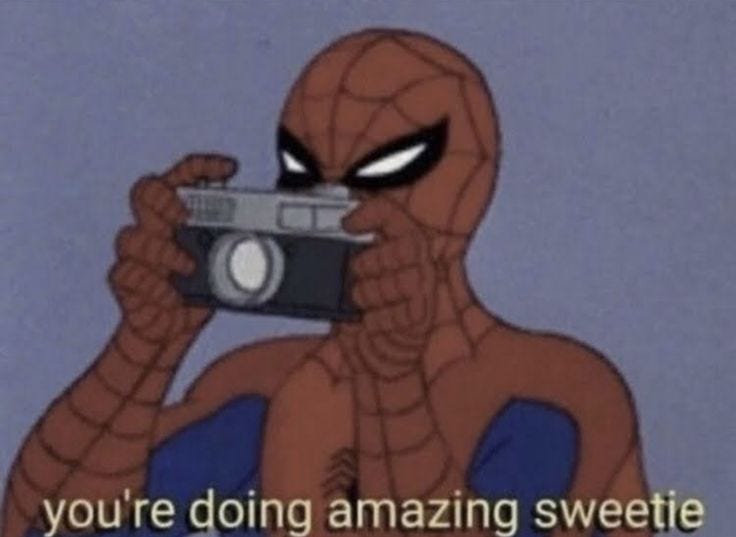 This may contain: spider - man holding up an old camera with the caption you're doing amazing sweetie