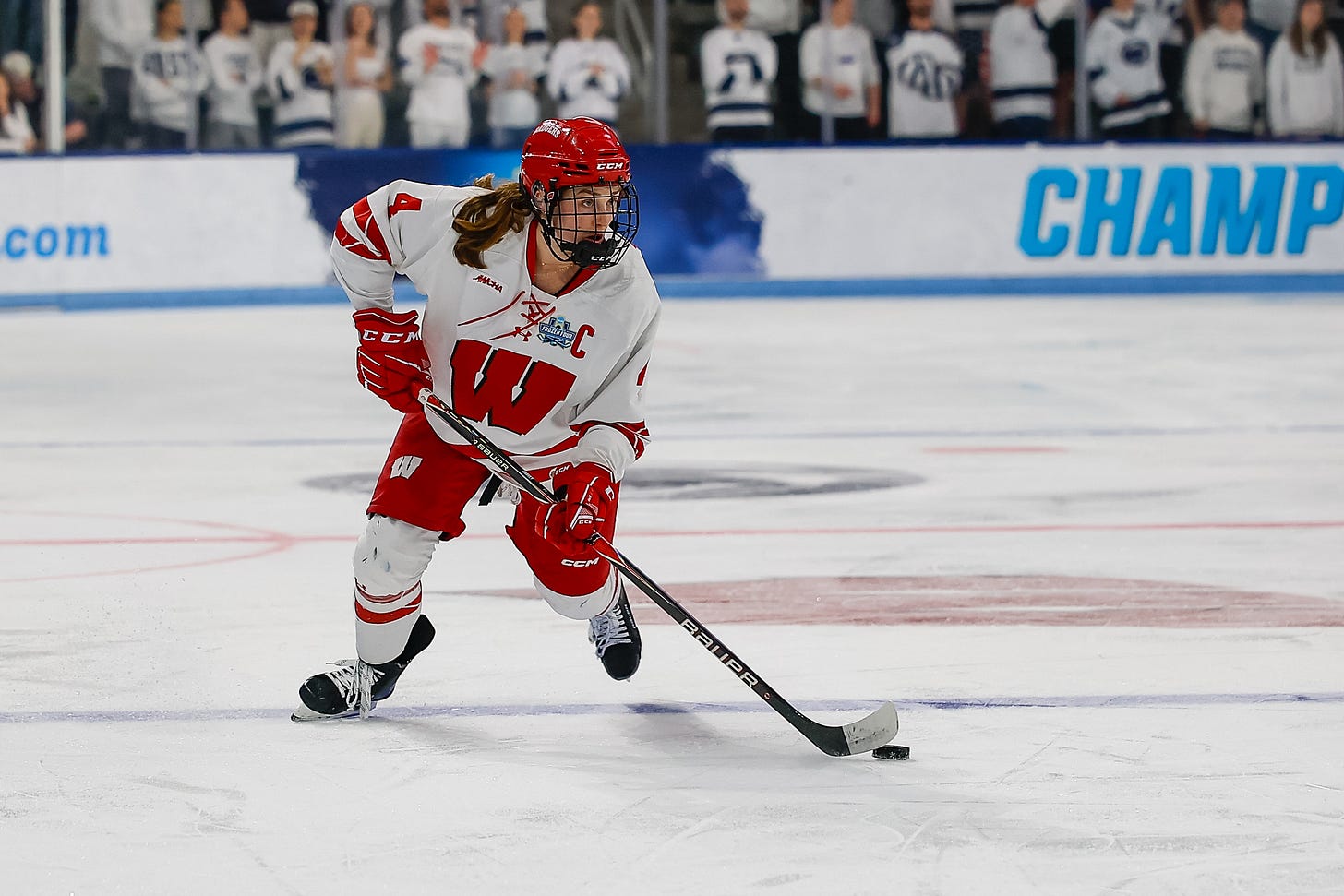 Wisconsin women's hockey defender Caroline Harvey carries the puck over the blue line into the offensive zone Wisconsin women's hockey defender Caroline Harvey carries the puck over the blue line into the offensive zone