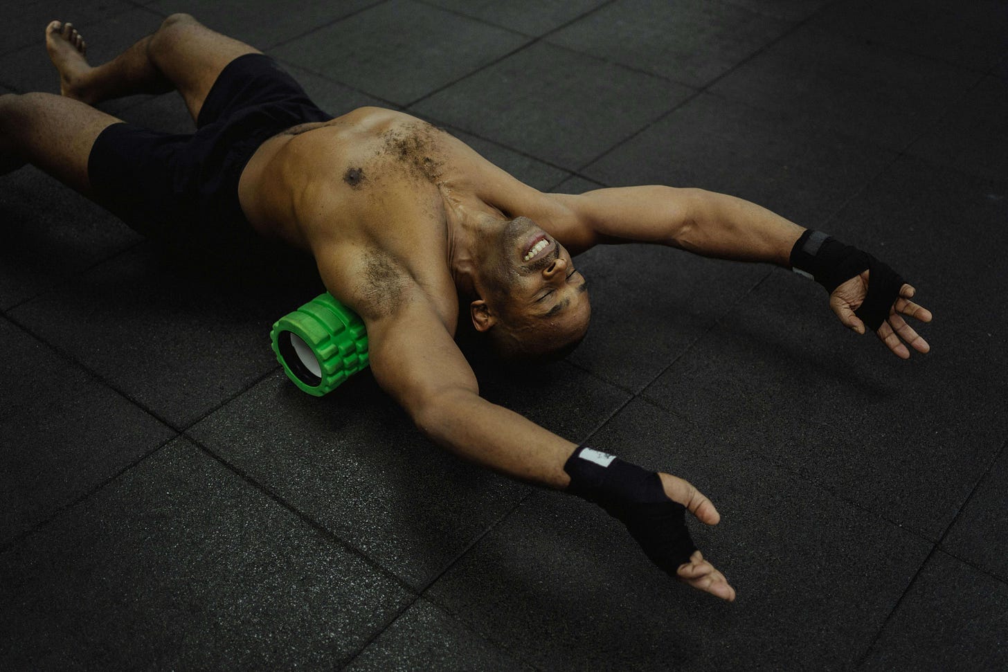 Man using a foam roller on his legs, demonstrating targeted mobility work to ease muscle tension.