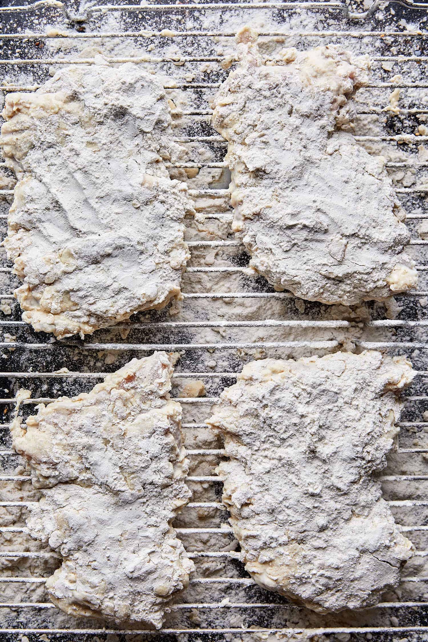 chicken ready to be fried after being placed in a wet and dry mixture of seasonings. chicken ready to be fried after being placed in a wet and dry mixture of seasonings.