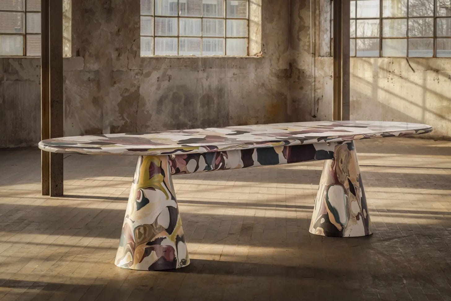 Melting Pot Table by Dirk van der Kooij, made from recycled plastic with a colorful marbled surface, displayed in an industrial loft space. Melting Pot Table by Dirk van der Kooij, made from recycled plastic with a colorful marbled surface, displayed in an industrial loft space.