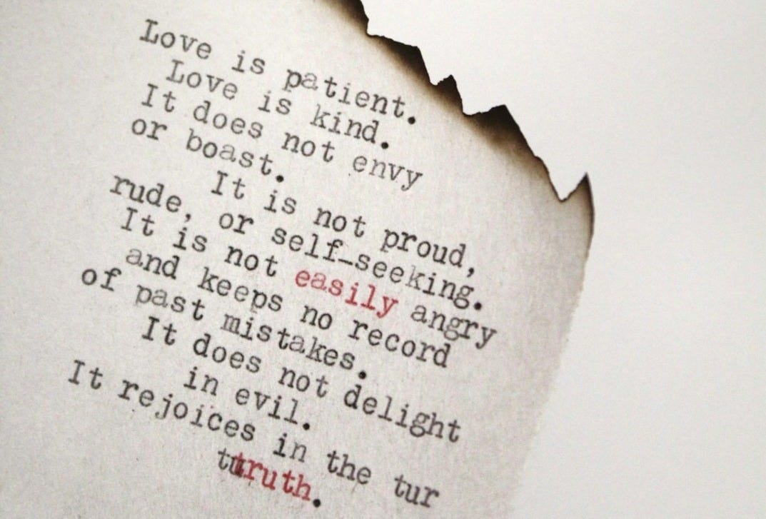 Love is patient Love is kind printed on burned paper Love is patient Love is kind printed on burned paper