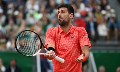 Novak Djokovic gestures to his players' box during the game. Novak Djokovic gestures to his players' box during the game.