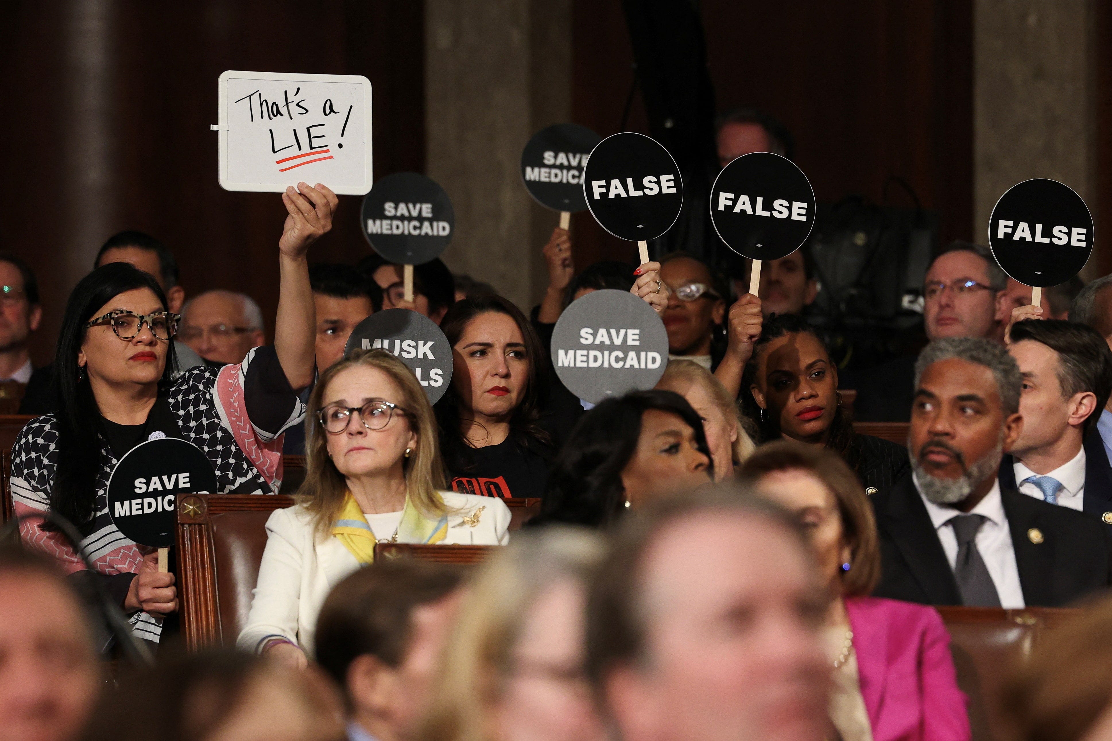 Democrats protest Trump's speech to Congress with disruption, exits and solemn signs | Reuters