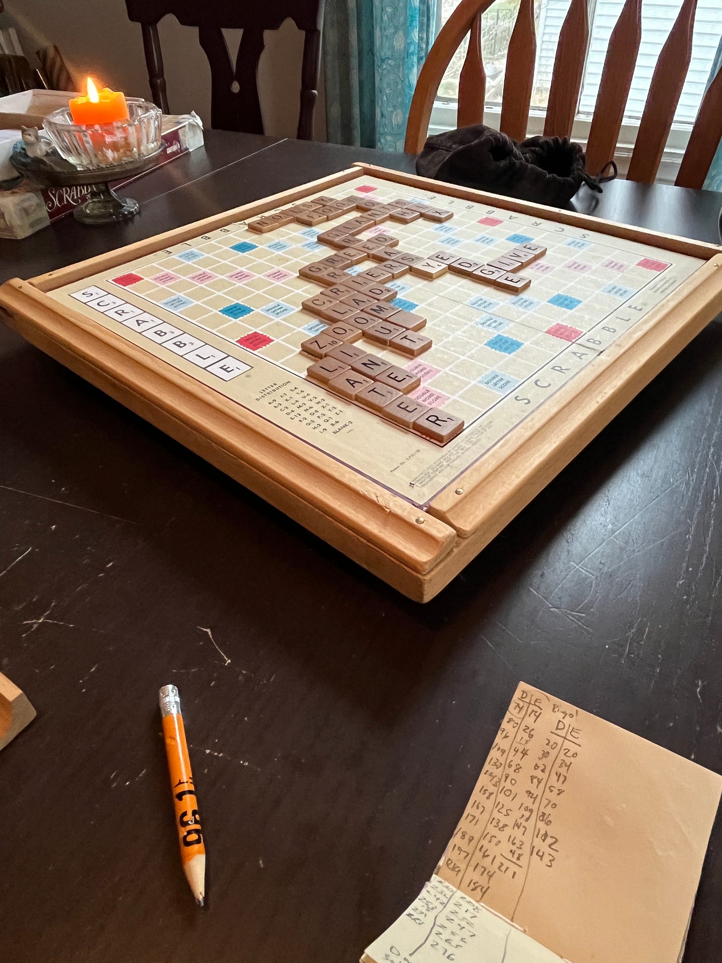 A Scrabble board on my table, set up in mid-game. There's also a nice candle flickering in the background.
