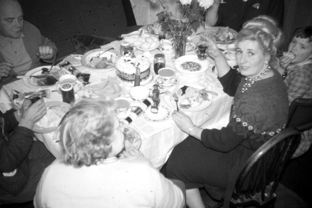 girl in white long sleeve shirt sitting on brown wooden chair