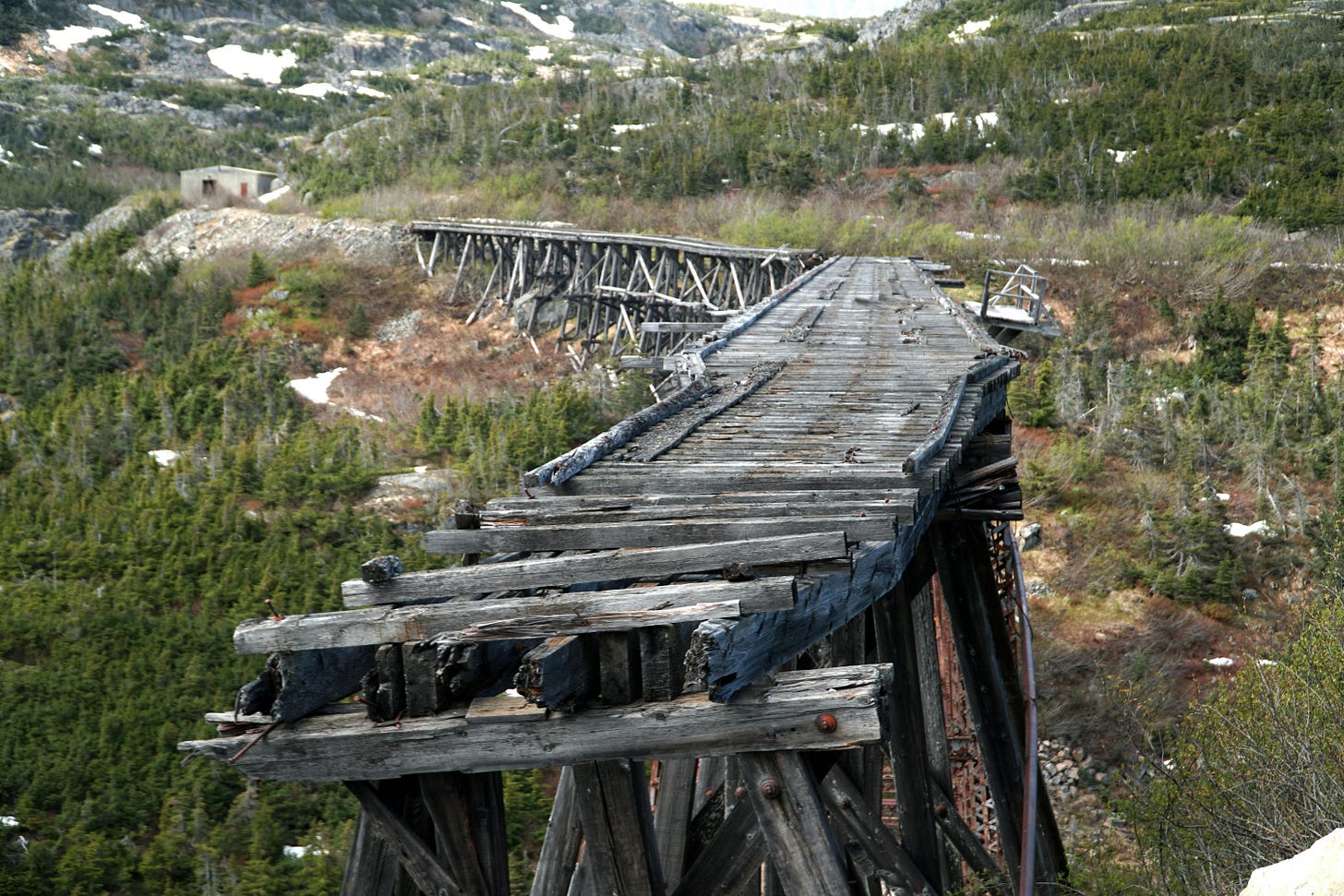 a broken wooden railroad bridge