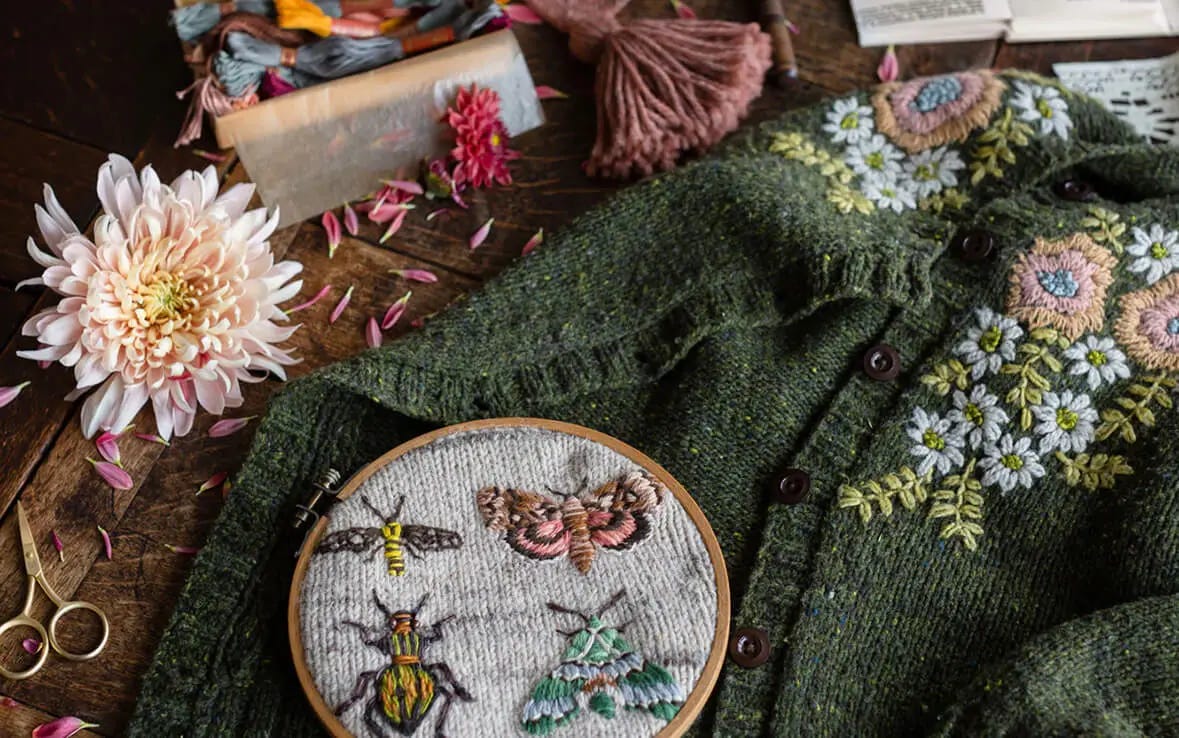 loop with embroidered insects and green cardigan with embroidered flowers