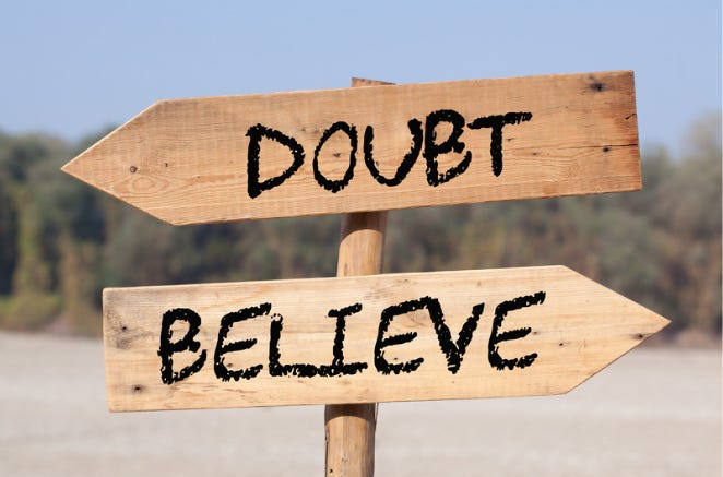 a sign with two wooden arrows: doubt points to the left, believe points to the right. 