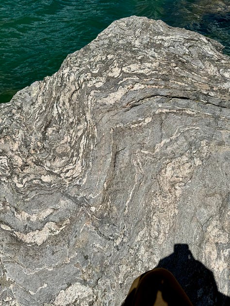 Images of rocks with repeated, waving patterns