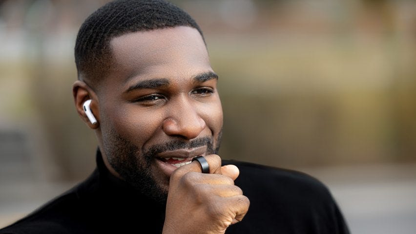 Photo of a man speaking into his WIZPR smart ring by VTouch
