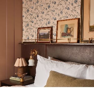 bottle, display in shop, bed with vintage frames photos.