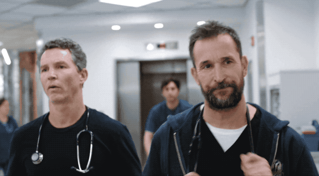 doctors stroll down a hallway and a naked person runs out