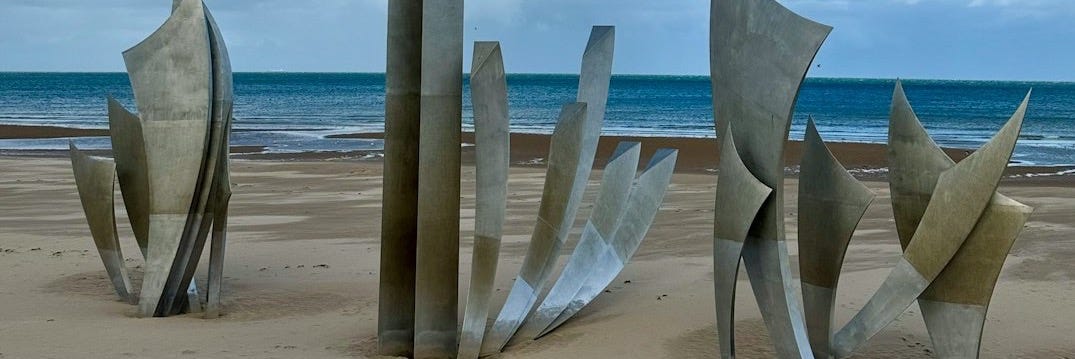 A group of sculptures sitting on top of a sandy beach