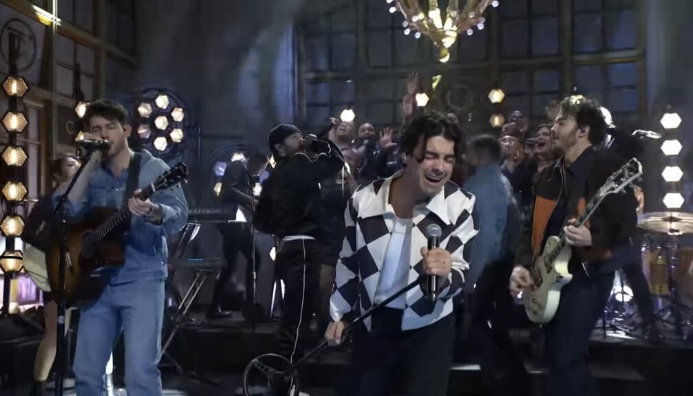 The Jonas Brothers on stage with Jon Bellion