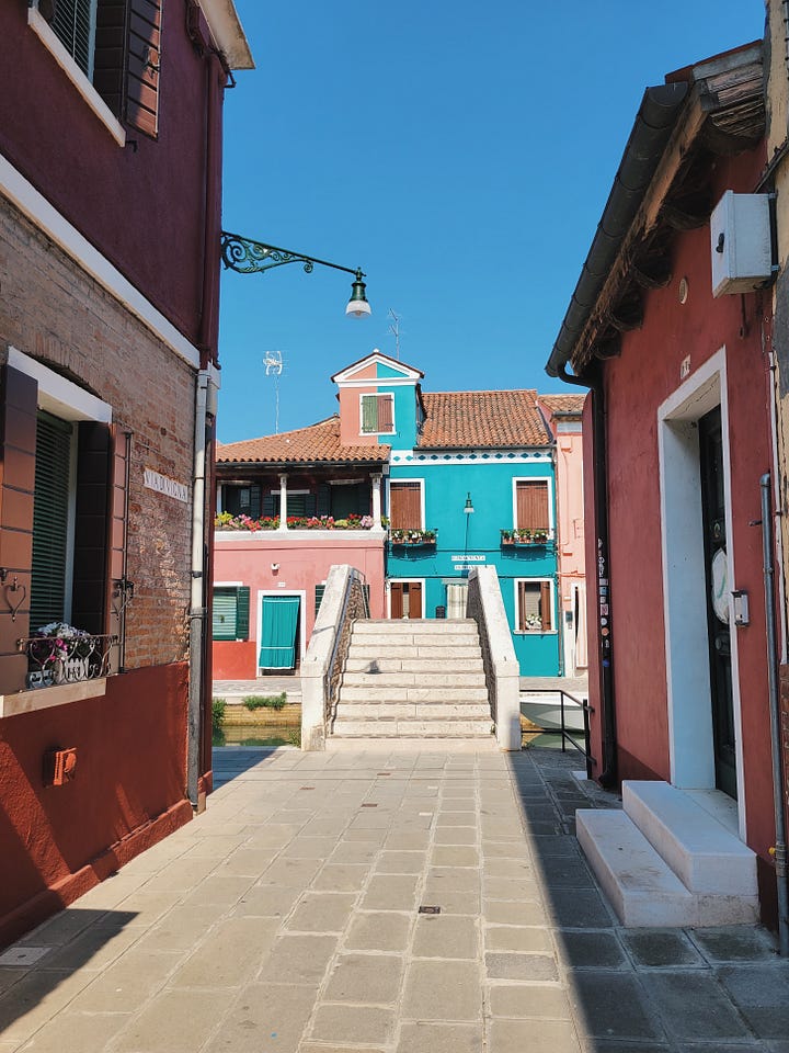 Two views of Burano: colorful houses reflected in a canal lined with boats, and a stone footbridge framed by pink and turquoise buildings