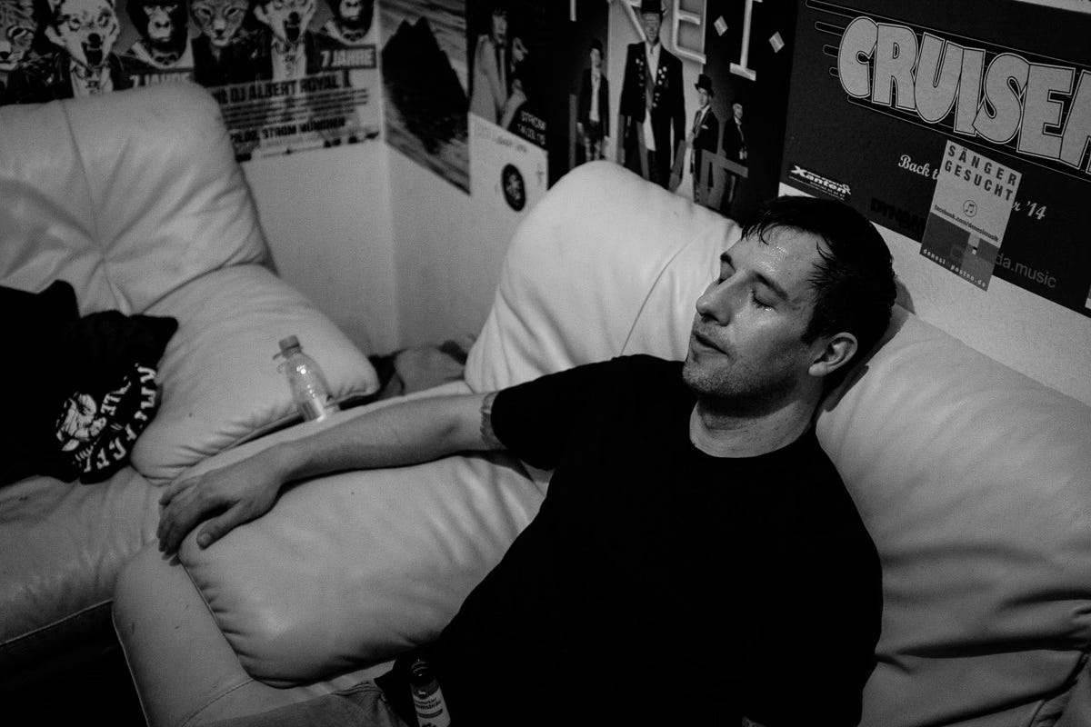 The author in the backstage room after a concert looking tired