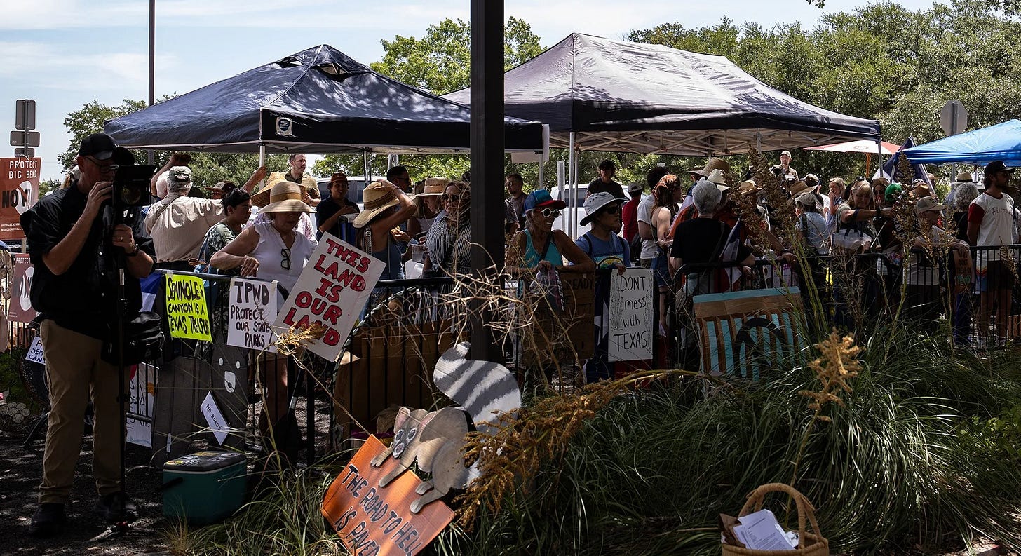 Dozens gather in opposition to border infrastructure projects in the Big Bend region before the Texas Parks and Wildlife Commission's public meeting in Austin on Aug. 18, 2026. (Photo by Kaylee Greenlee for the Texas Tribune) Dozens gather in opposition to border infrastructure projects in the Big Bend region before the Texas Parks and Wildlife Commission's public meeting in Austin on Aug. 18, 2026. (Photo by Kaylee Greenlee for the Texas Tribune)