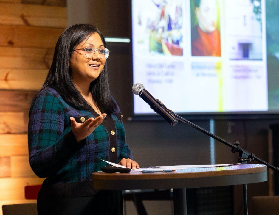 Female conference speaker standing at podium