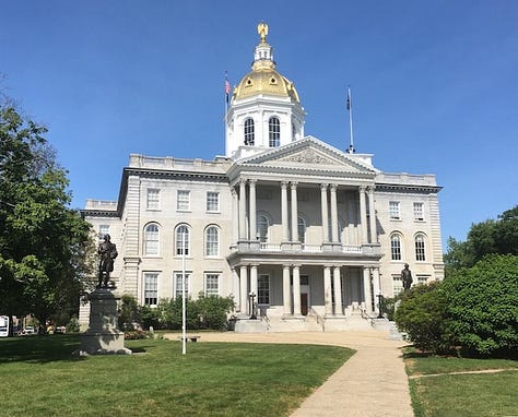 Lake under blue sky, with one mountain in background; icon of Christ and St. Mary; exterior of New Hampshire State House