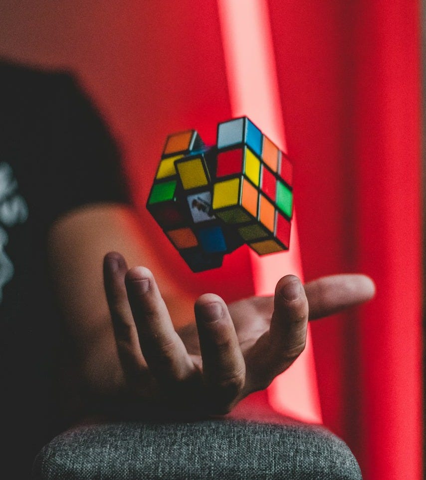 person tossing 3x3 Rubik's cube person tossing 3x3 Rubik's cube