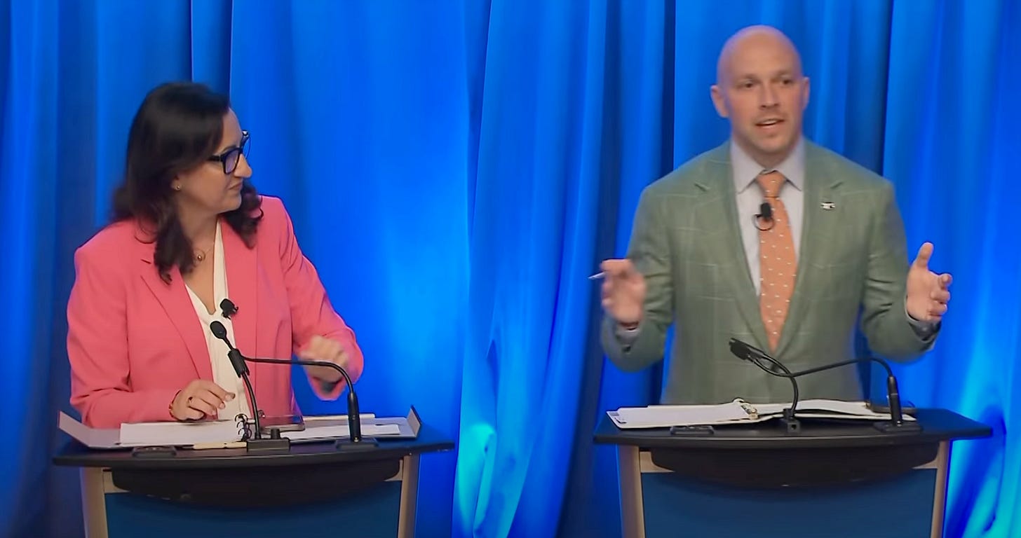 Bradford and Bailao on stage at a recent housing debate, standing behind podiums Bradford and Bailao on stage at a recent housing debate, standing behind podiums