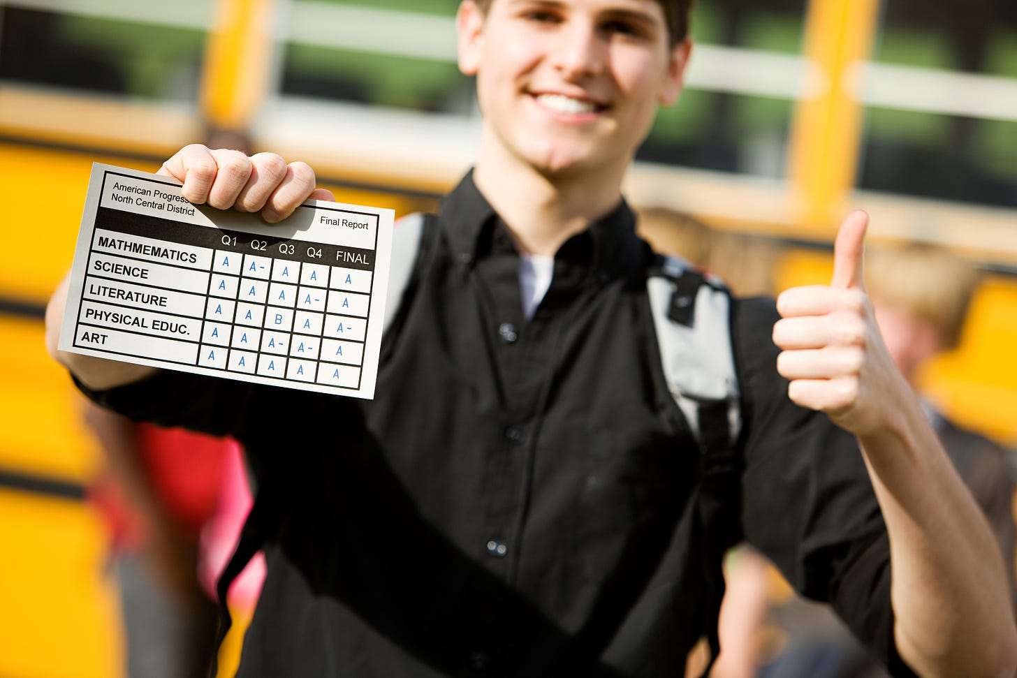 Student holding a report card Student holding a report card
