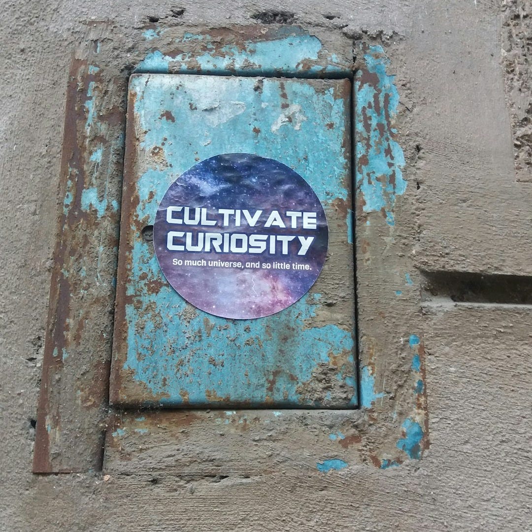 a rusted out sign on the side of a building