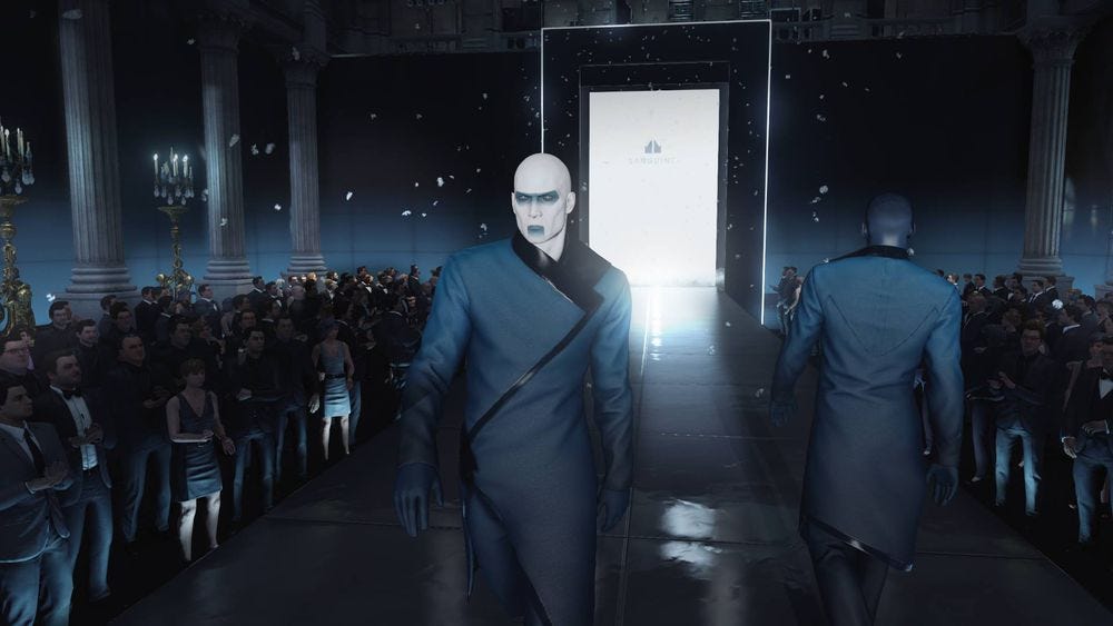 A screenshot from HITMAN (2016) featuring Agent 47 undercover as a runway model.