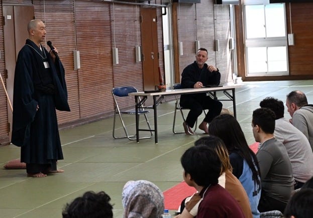 A person in a robe speaking to a group of people

AI-generated content may be incorrect.