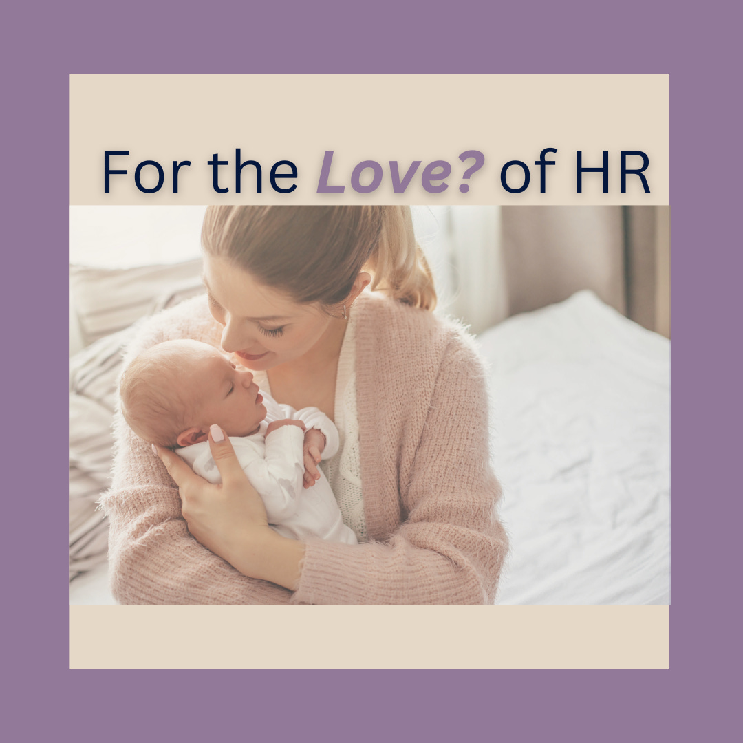 New mom smiling while holding baby