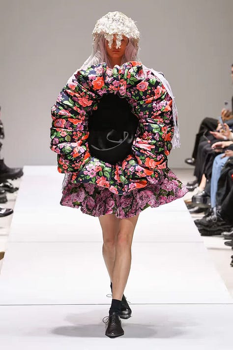 Left to right: Comme des Garçons Fall/Winter 1997 (Body Meets Dress, Dress Meets Body), Spring/Summer 2018 (sculptural florals), and Fall/Winter 2012 (flat form silhouettes), each exemplifying Rei Kawakubo’s ongoing interrogation of volume, distortion, and the limits of fashion as a wearable medium.