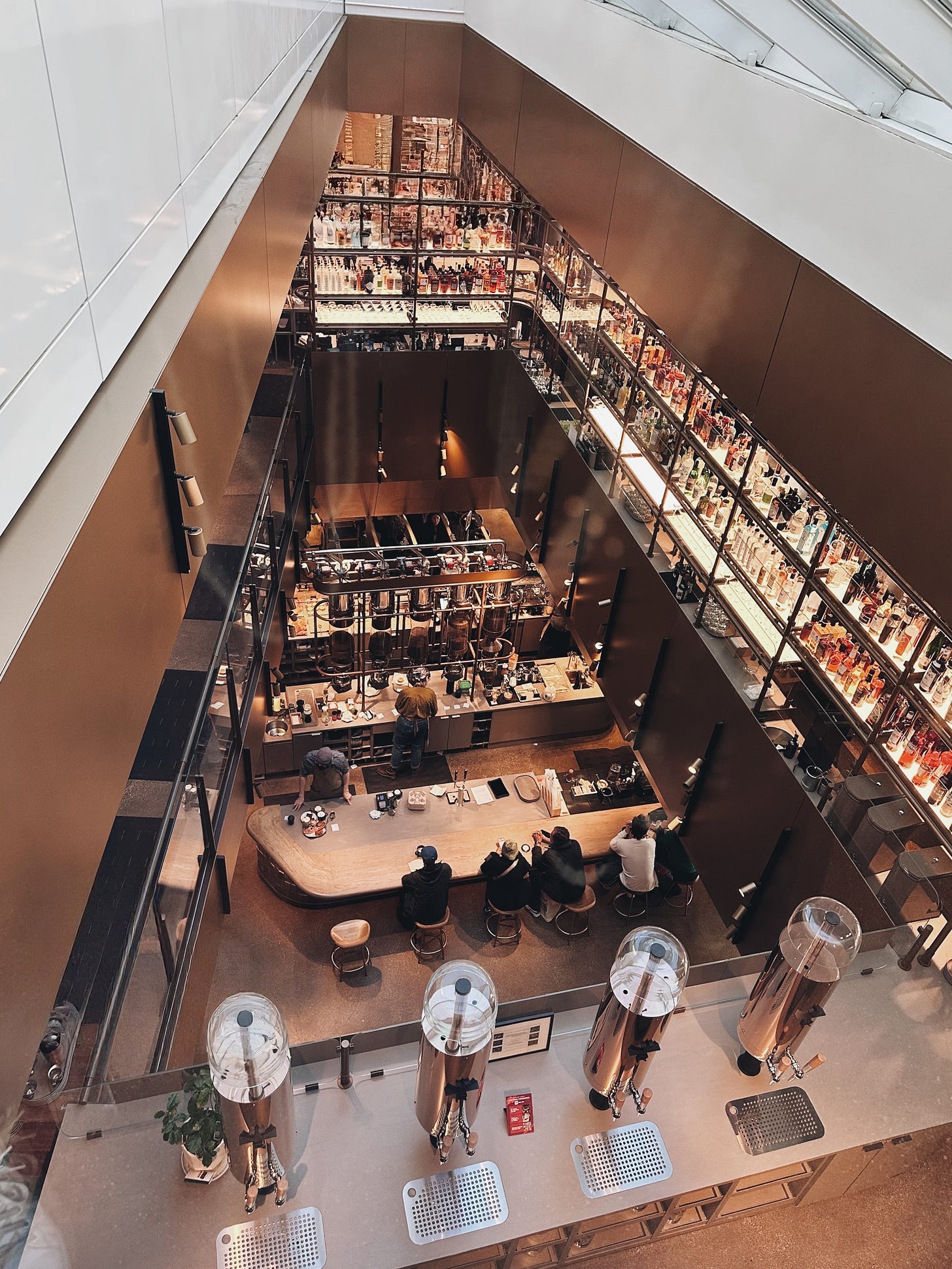 Overhead view from the fourth floor of the Starbuck's Reserve Roastery in Chicago featuring their extensive bar and coffee making.