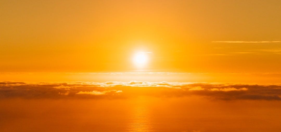people on top of hill under white clouds golden hour photography