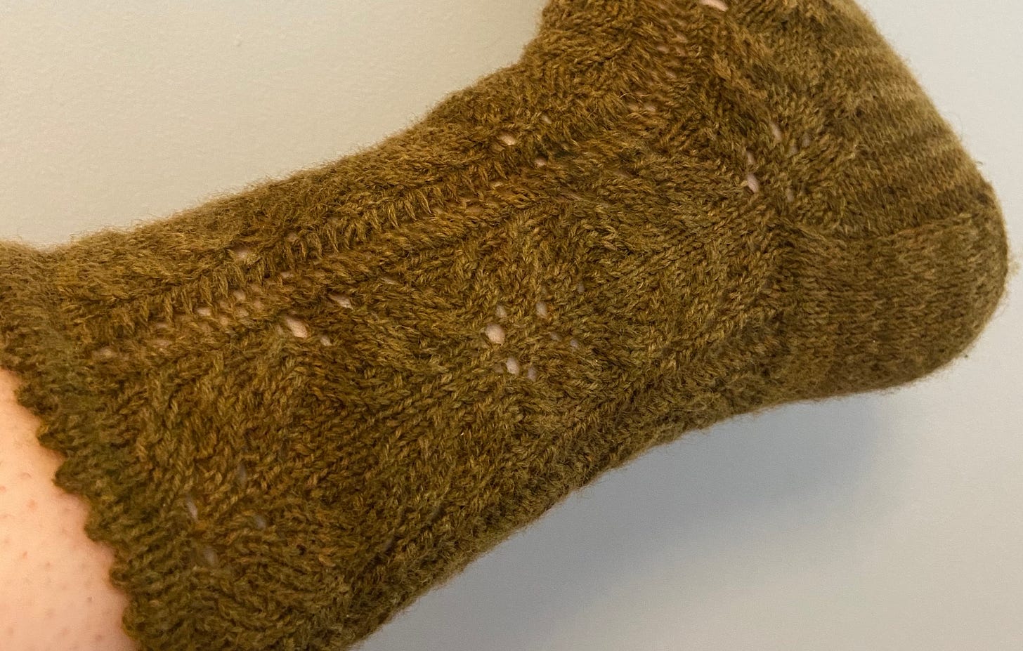 a close up of the sock, showing a lacy x's and o's kind of pattern
