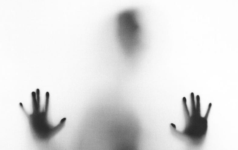 person behind fog glass